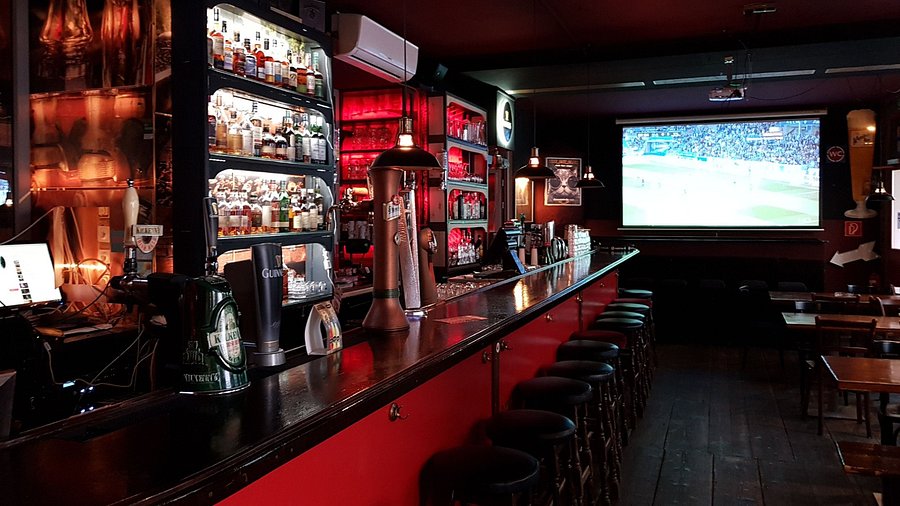 Guests watching sports together on the big screen at Isaac's
